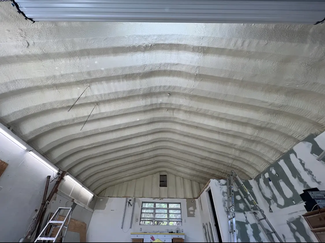 Spray polyurethane foam applied to the underside of a metal roof deck in Huron